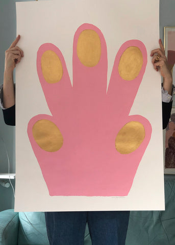 a woman is holding a pink cake