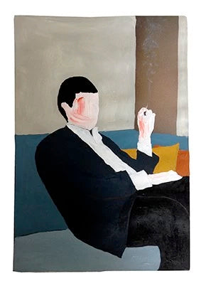 a man in a suit and tie sitting in a chair